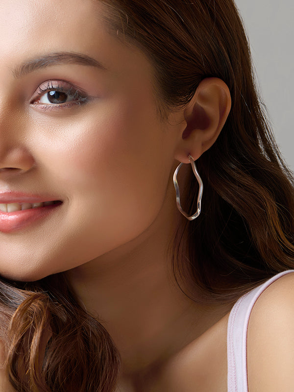 Model wearing Silver Wave Twist Hoops