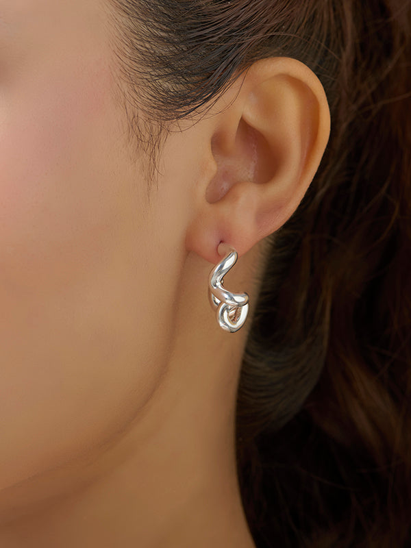 Model wearing Lumin dual arc silver earrings
