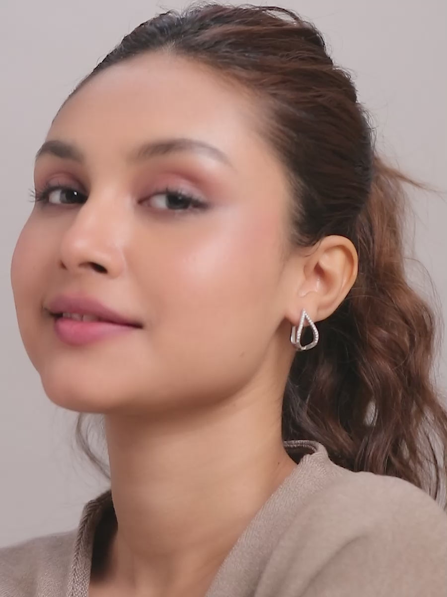Load video: Rhodium Hoop Earrings with Structured Teardrop Shape