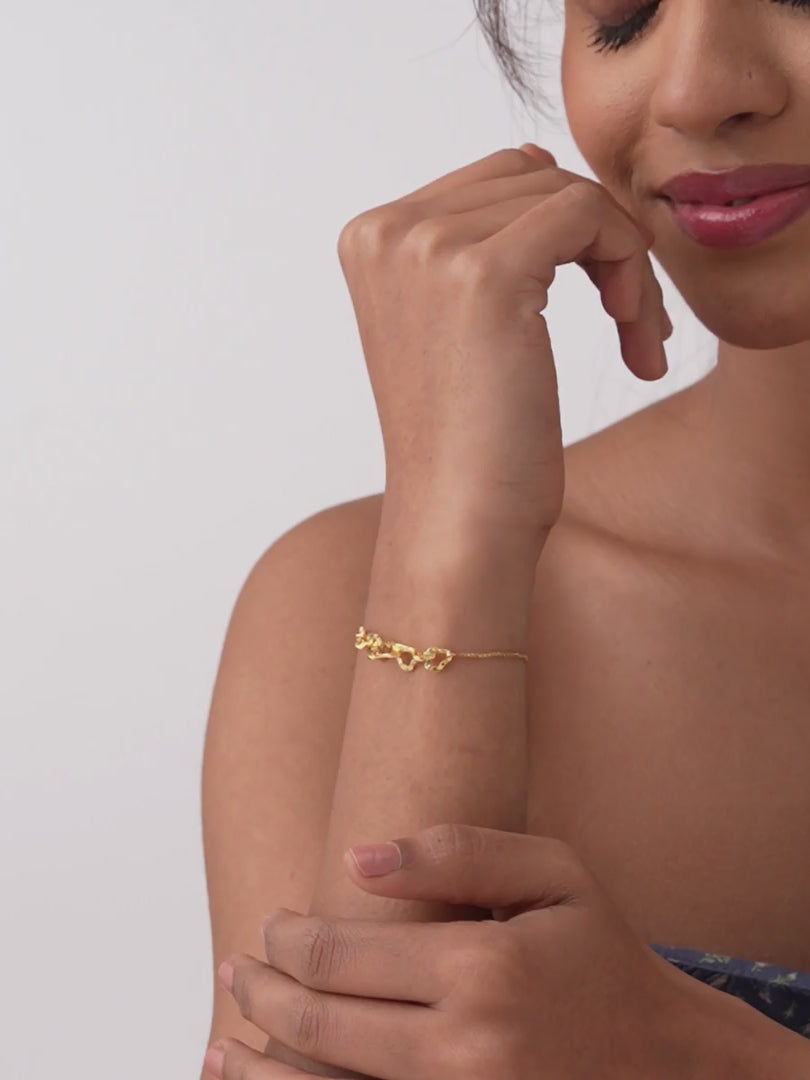 Load video: Amara Intertwined Hearts Adjustable Gold Bracelet